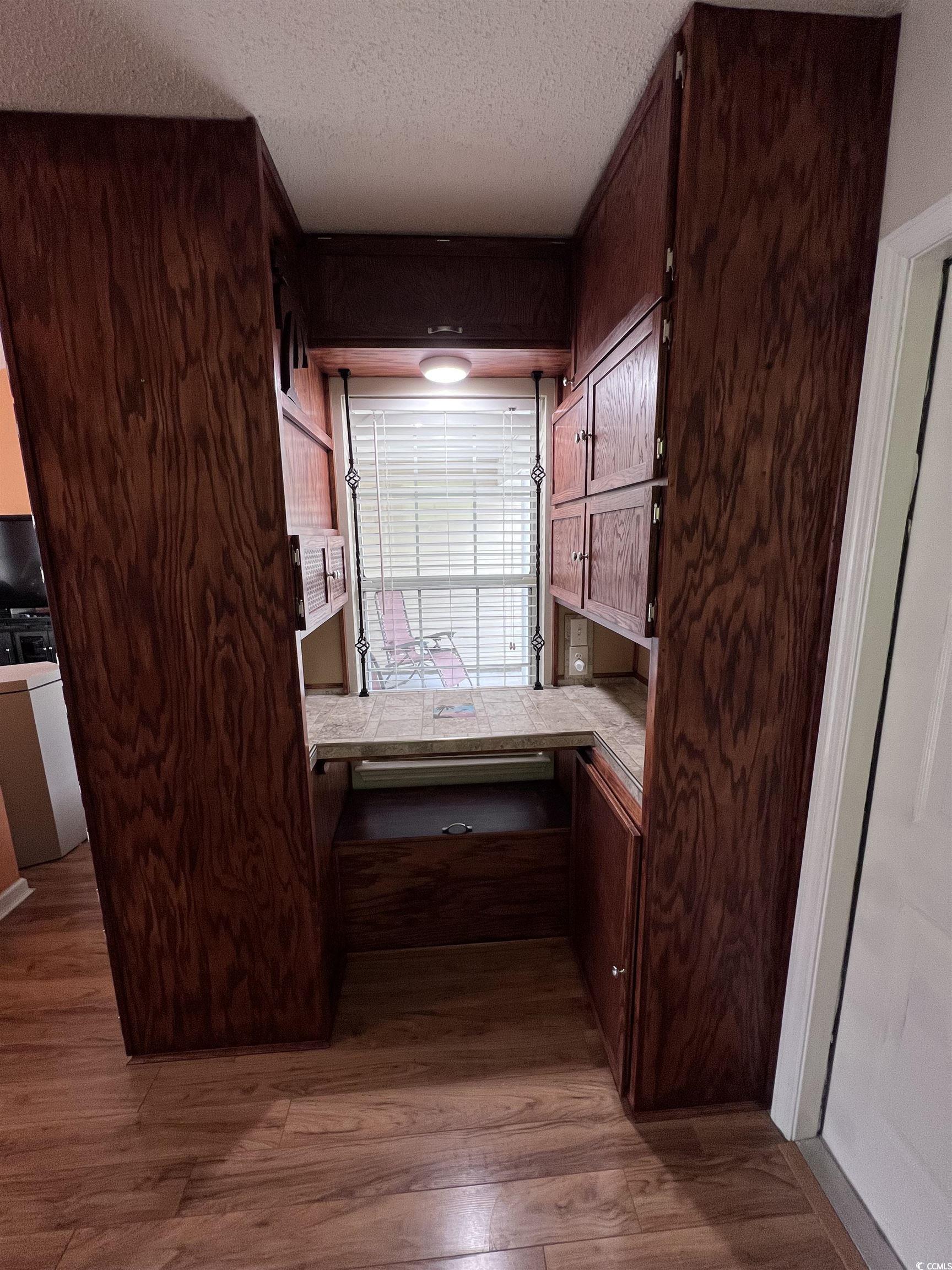 2560 Wild Game Trail Myrtle Beach, SC 29588 - Photo 9 of 24 Interior space with wood finished floors, a textured ceiling, and built in study area