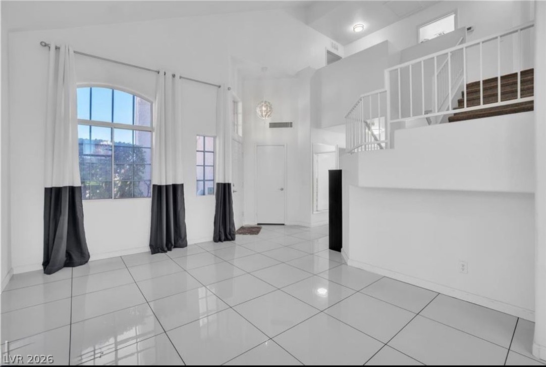 6429 Winding Ridge Las Vegas, NV 89156 - Photo 14 of 22 A spacious entry area with soaring ceilings and an elegant staircase.