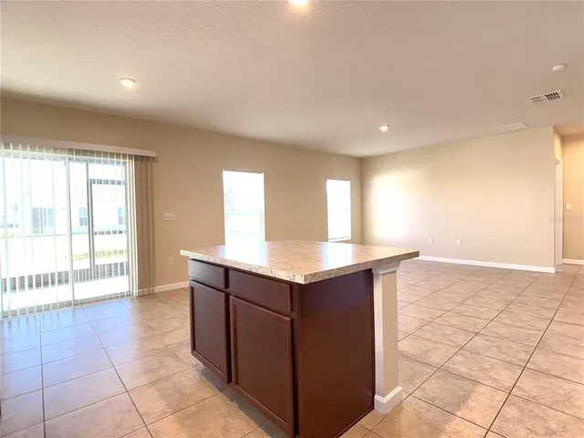 a kitchen with stainless steel appliances granite countertop a sink and a stove