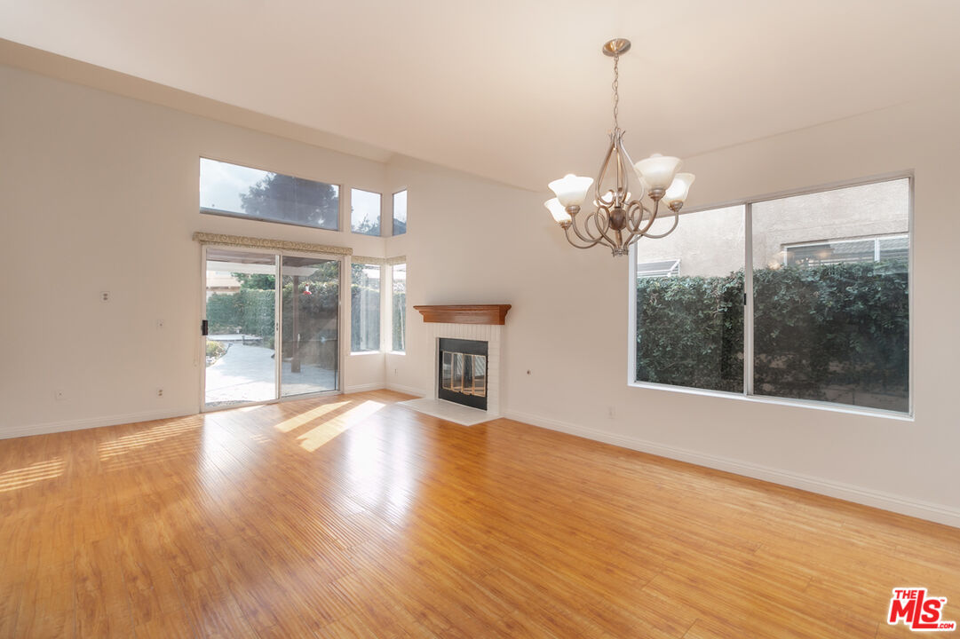 552 Fairfield Road Simi Valley, CA 93065 - Photo 2 of 13 a view of an empty room with wooden floor and a window