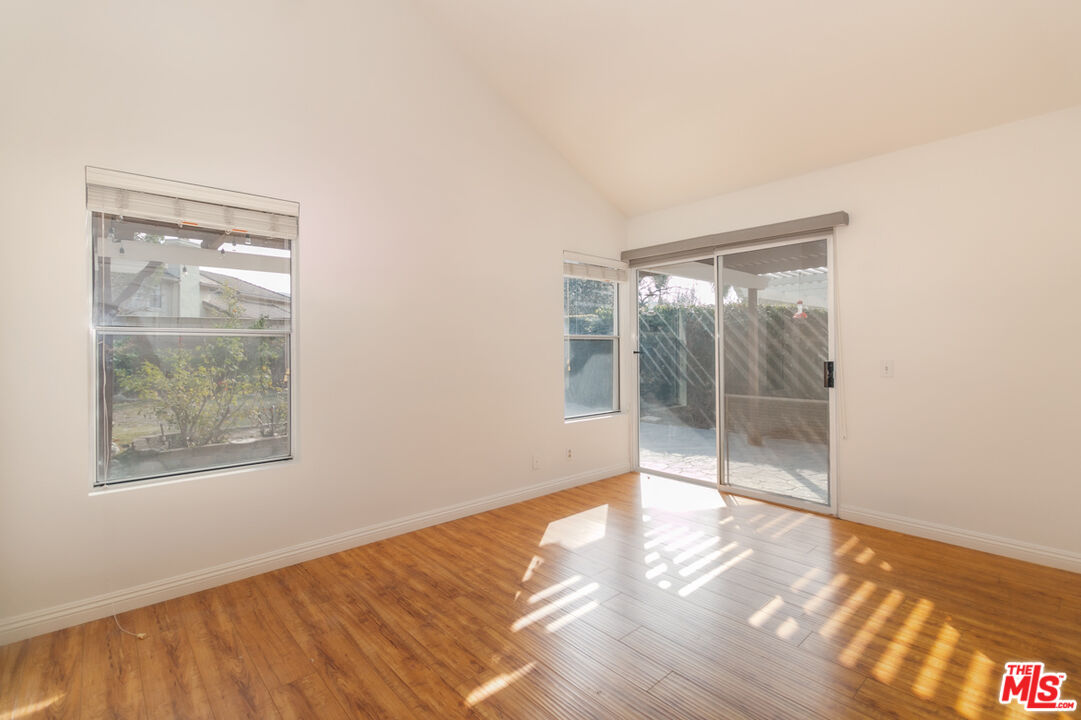 552 Fairfield Road Simi Valley, CA 93065 - Photo 4 of 13 a view of an empty room with wooden floor and a window