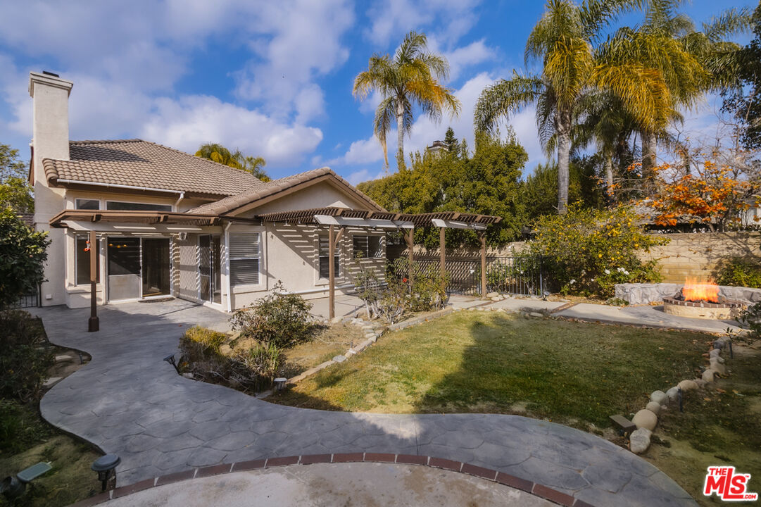 552 Fairfield Road Simi Valley, CA 93065 - Photo 9 of 13 a view of a house with a yard and palm trees