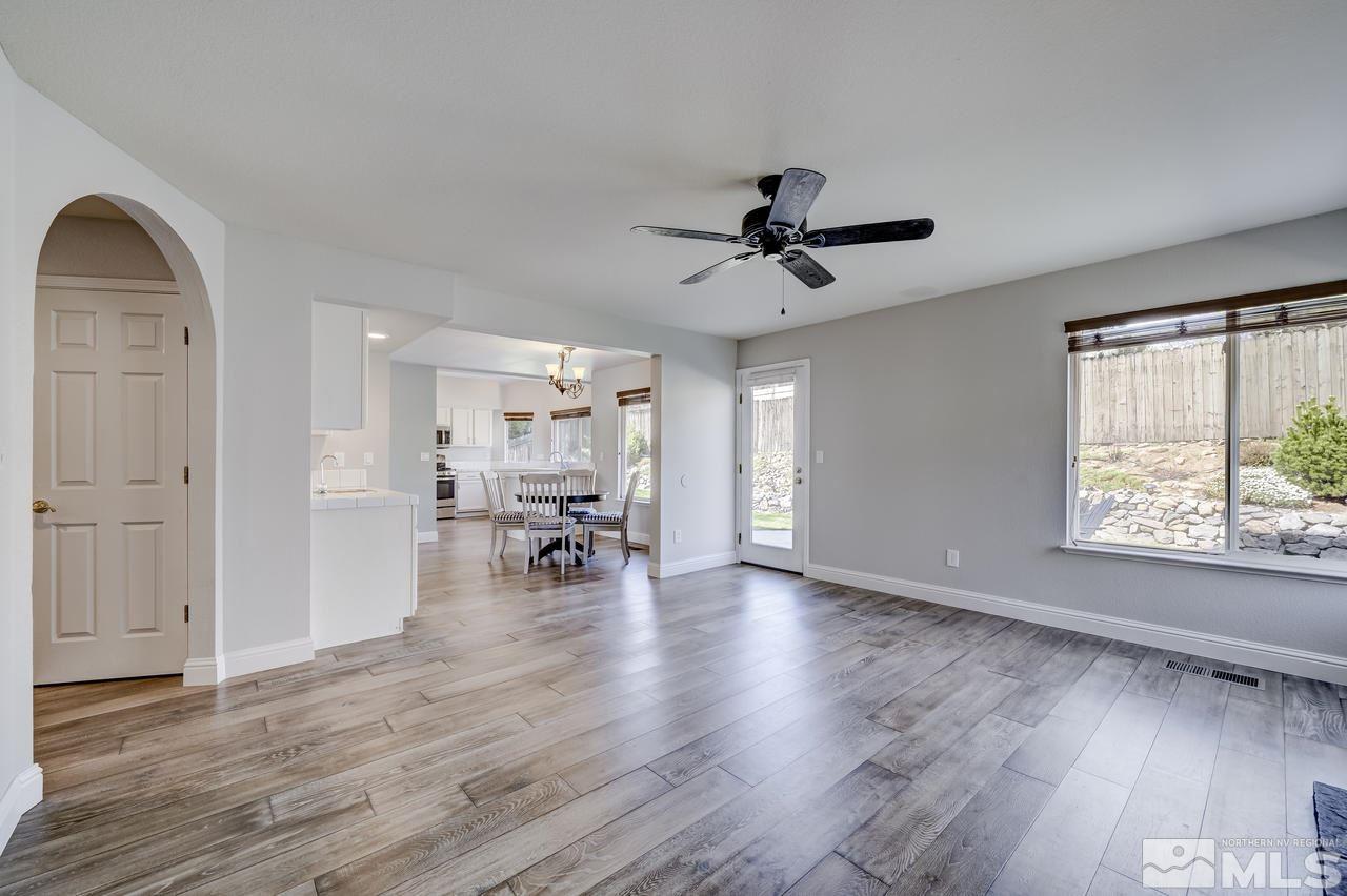 14435 Ghost Rider Drive Reno, NV 89511 - Photo 12 of 30 a view of a livingroom with hardwood floor and a ceiling fan