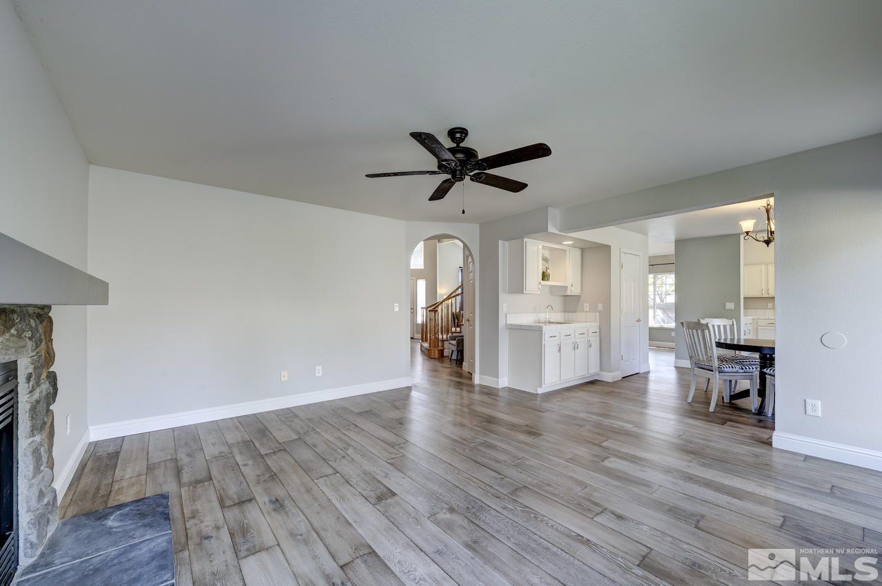 14435 Ghost Rider Drive Reno, NV 89511 - Photo 13 of 30 a view of empty room with wooden floor and ceiling fan