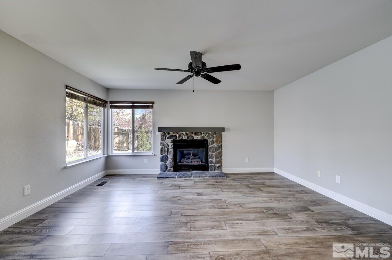 14435 Ghost Rider Drive Reno, NV 89511 - Photo 15 of 30 a view of an empty room with a fireplace and a window