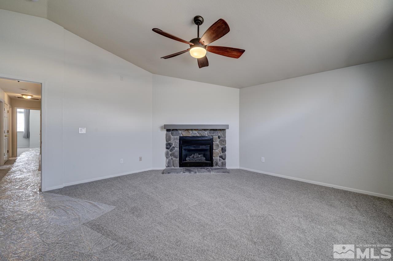 14435 Ghost Rider Drive Reno, NV 89511 - Photo 16 of 30 an empty room with fireplace and fan