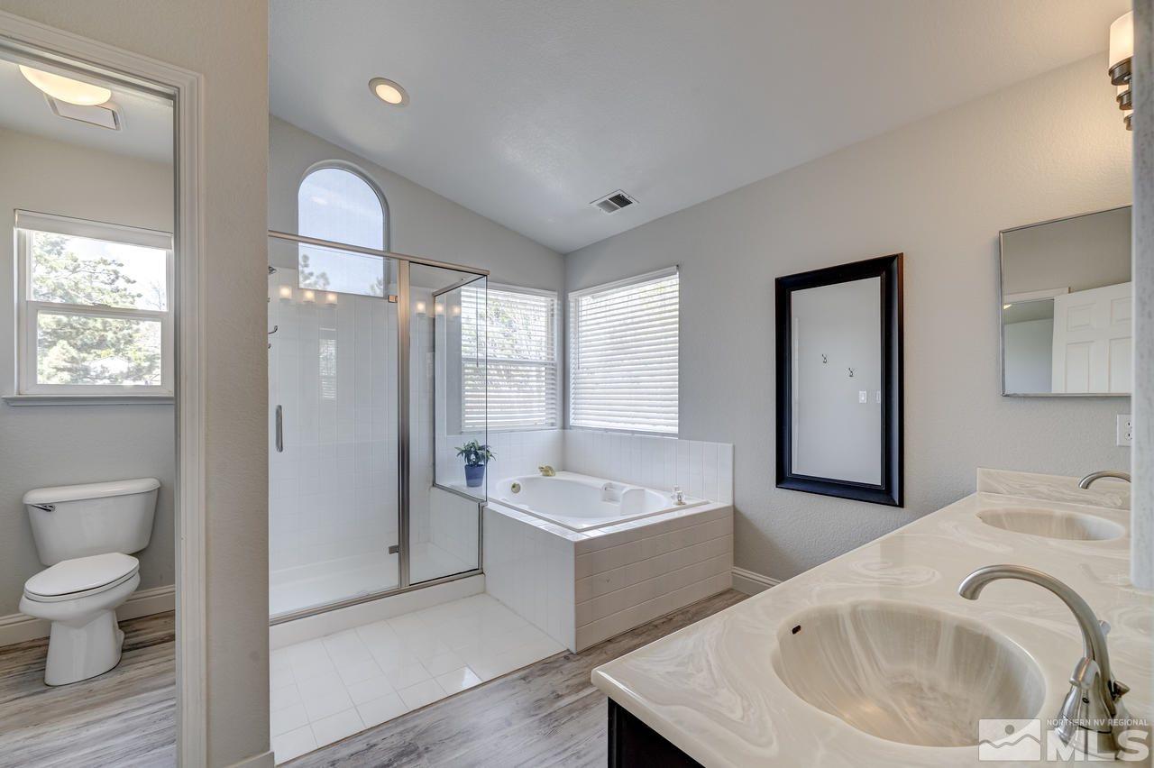 14435 Ghost Rider Drive Reno, NV 89511 - Photo 17 of 30 a bathroom with a sink a toilet and a bathtub
