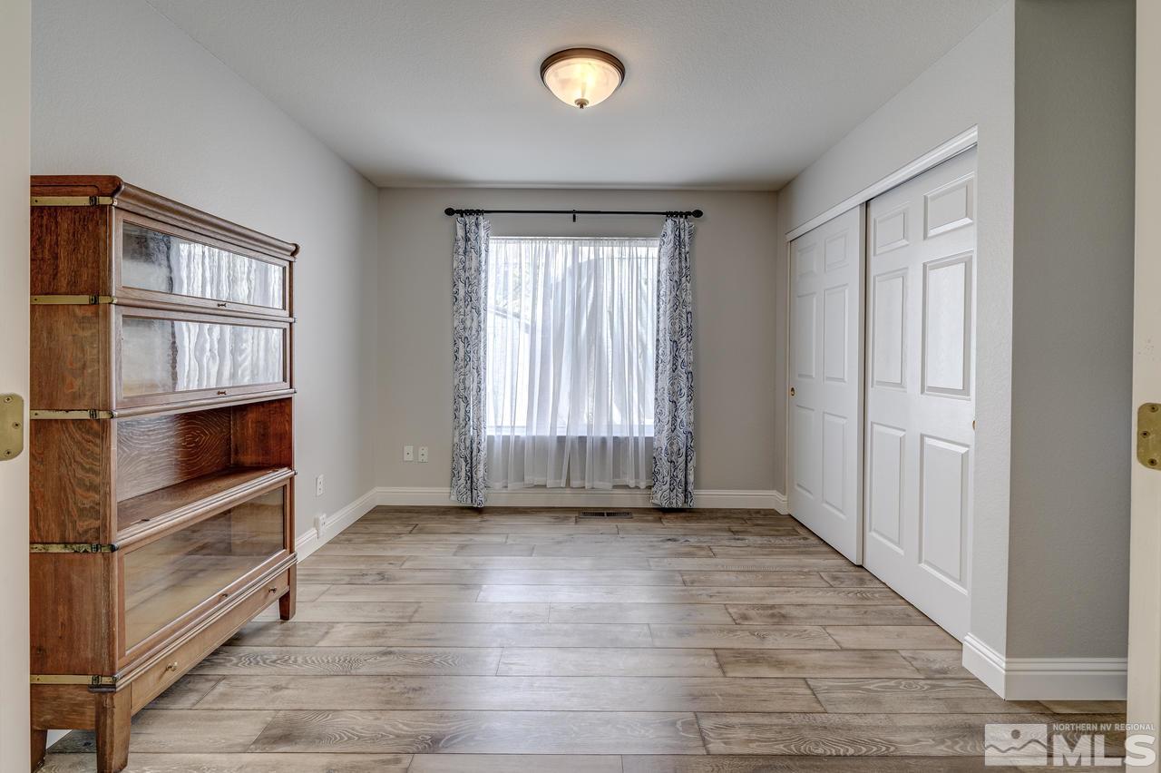 14435 Ghost Rider Drive Reno, NV 89511 - Photo 20 of 30 a view of an empty room with a window and wooden floor