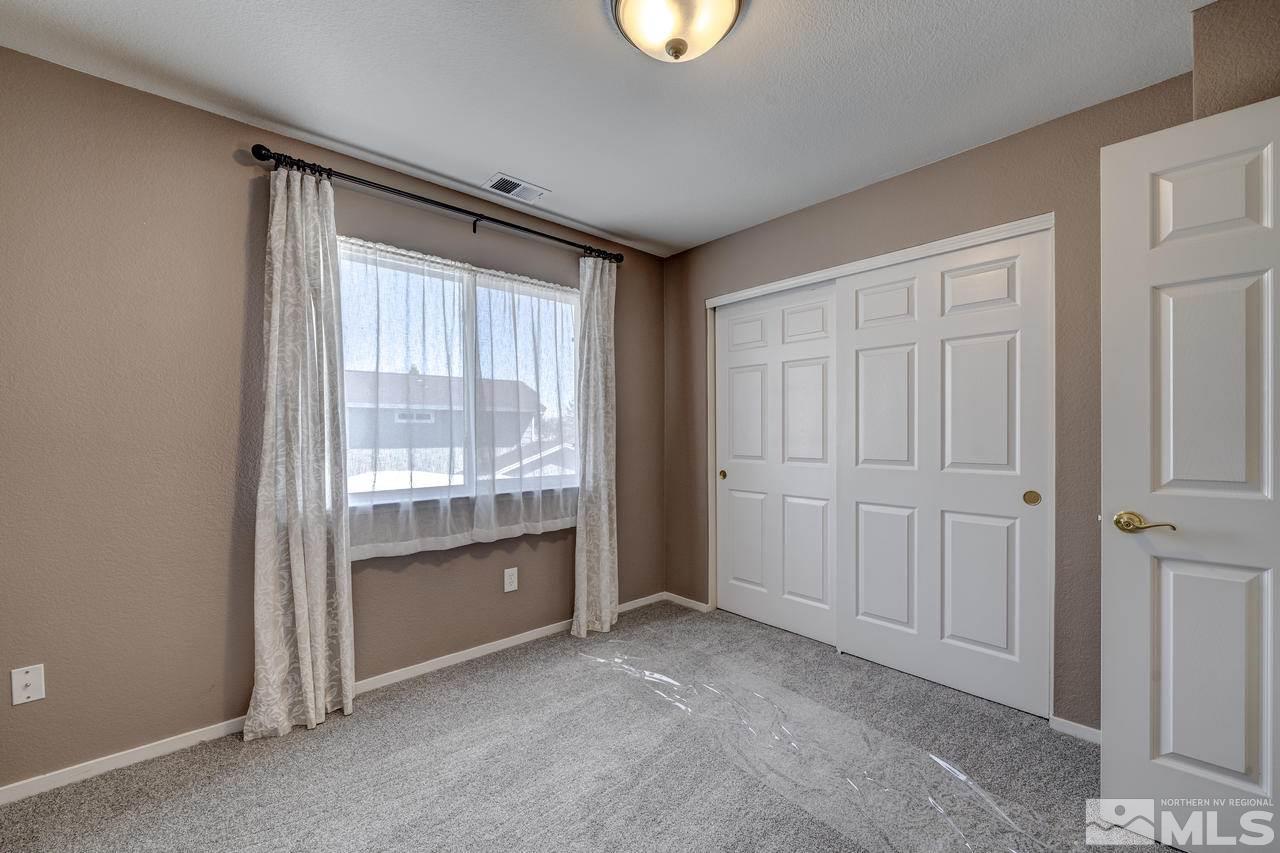 14435 Ghost Rider Drive Reno, NV 89511 - Photo 23 of 30 a view of an empty room with a window
