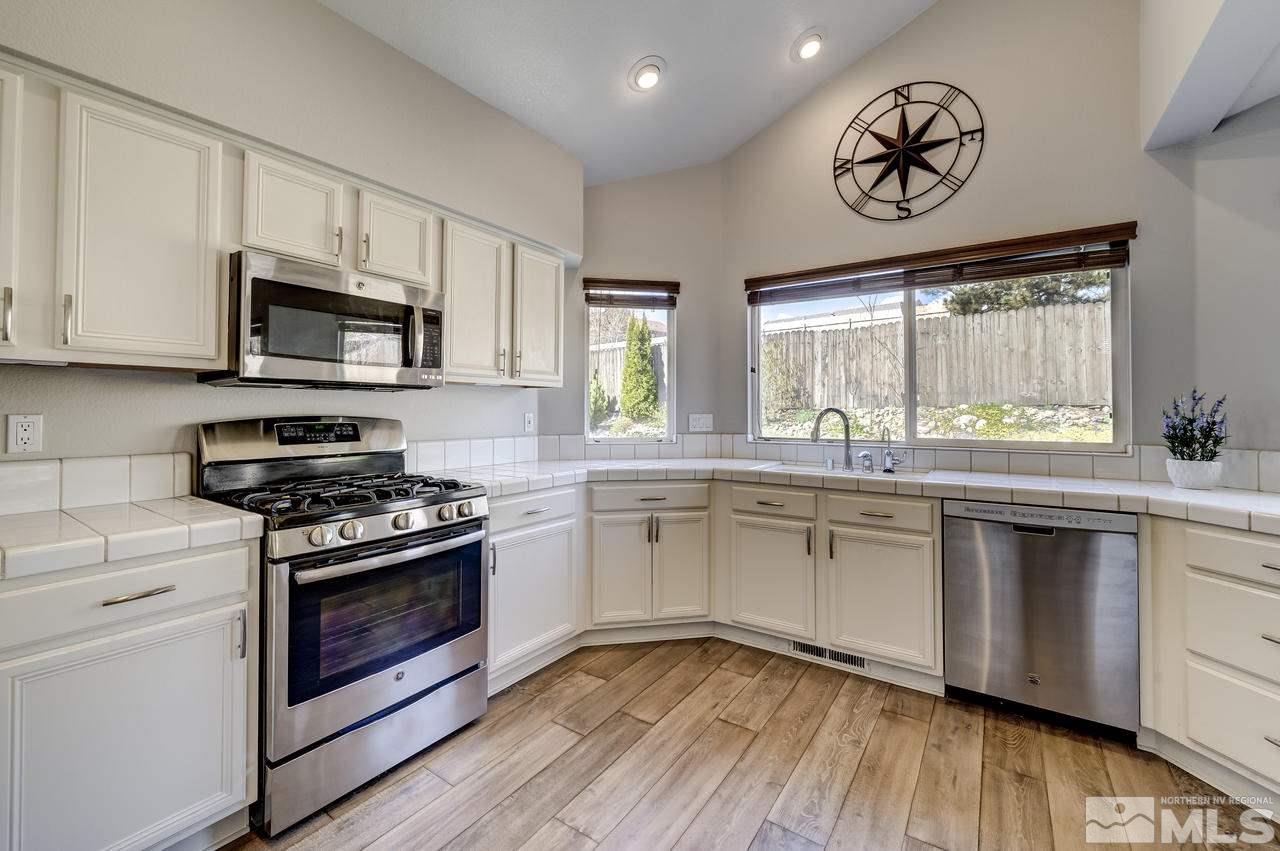14435 Ghost Rider Drive Reno, NV 89511 - Photo 8 of 30 a kitchen with a stove oven and sink