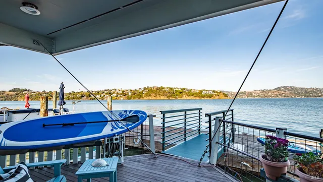 a view of a ocean with boats and trees in the background