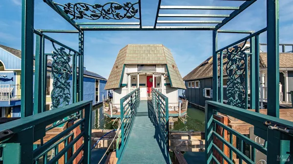 a kitchen with stainless steel appliances kitchen island granite countertop a table chairs and stove