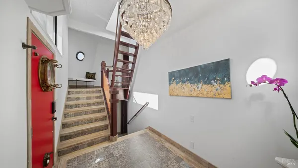 a view of a dining room with furniture large windows and wooden floor