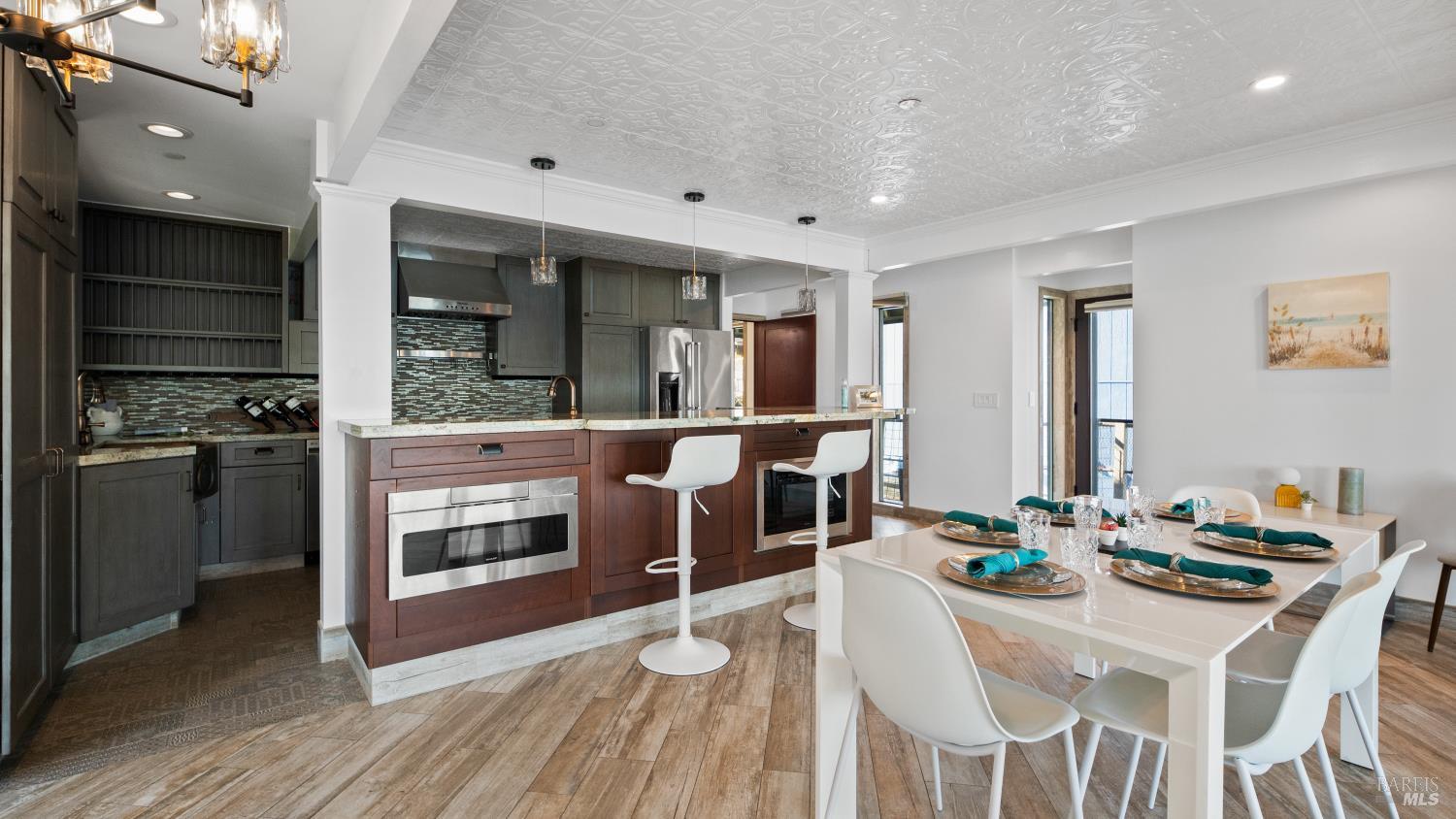 68 Issaquah Dock Sausalito, CA 94965 - Photo 40 of 81 a kitchen with stainless steel appliances kitchen island granite countertop a table chairs and stove