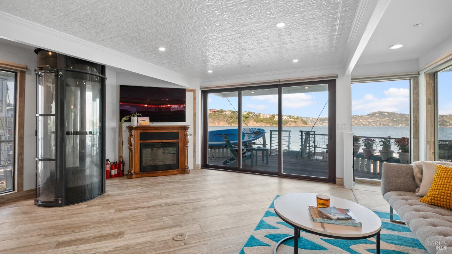68 Issaquah Dock Sausalito, CA 94965 - Photo 50 of 81 a living room with furniture a floor to ceiling window and wooden floor