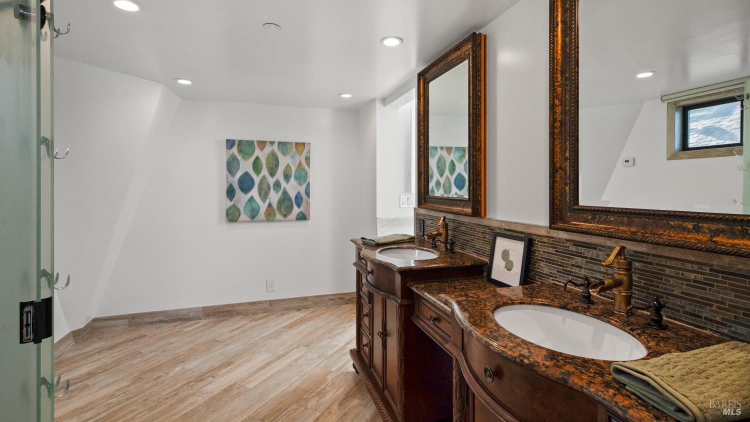 68 Issaquah Dock Sausalito, CA 94965 - Photo 62 of 81 a bathroom with a granite countertop double vanity and a mirror