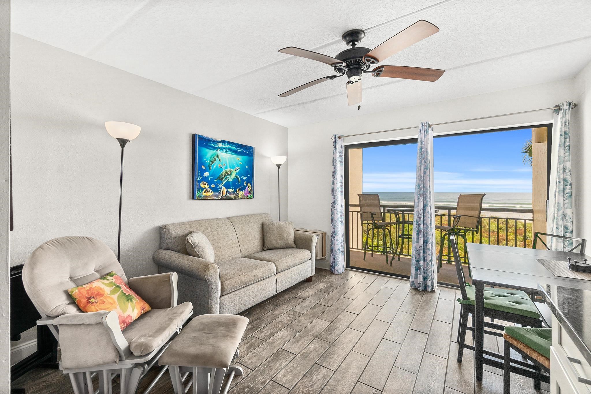 6970 A1A South, Unit 219 St. Augustine, FL 32080 - Photo 1 of 24 a living room with furniture a flat screen tv and a large window