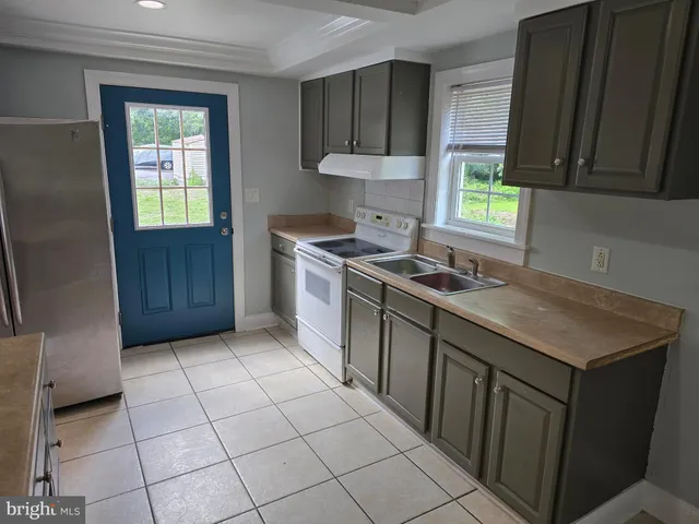 a kitchen with a sink stove and cabinets