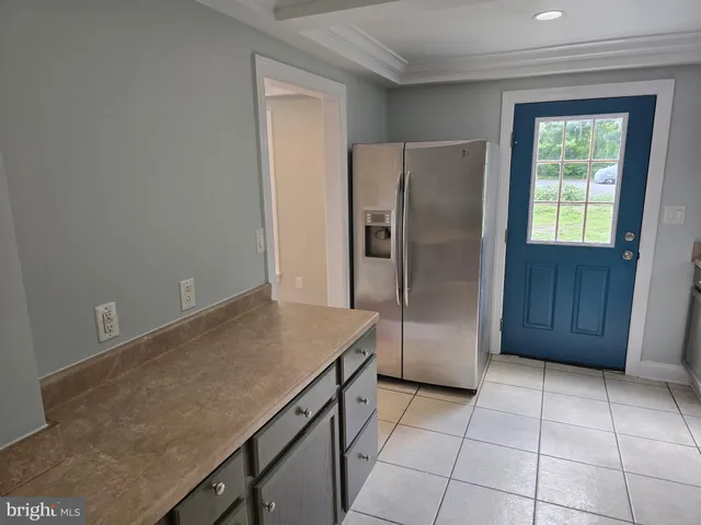 a kitchen with refrigerator and window