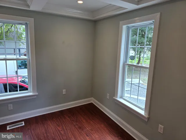 a view of a kitchen with a sink dishwasher and wooden floor