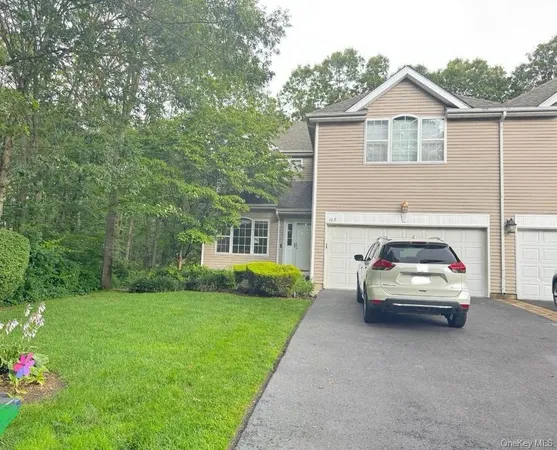 a view of car parked in front of house and yard