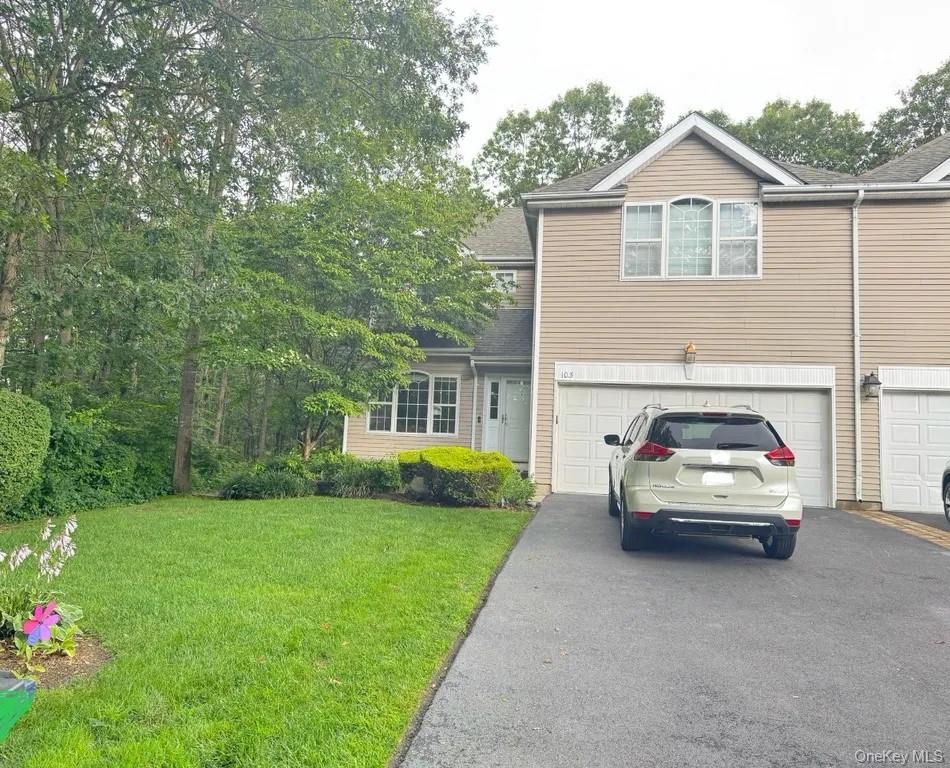 a view of car parked in front of house and yard