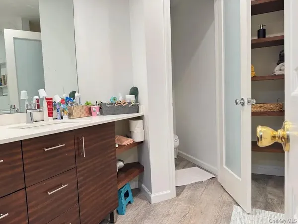 a view of bathroom with a sink and mirror