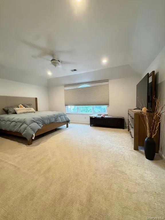 103 Sunflower Ridge Road Centereach, NY 11720 - Photo 2 of 16 a bedroom with furniture and a flat screen tv