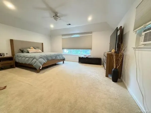 a spacious bedroom with a bed and a couch