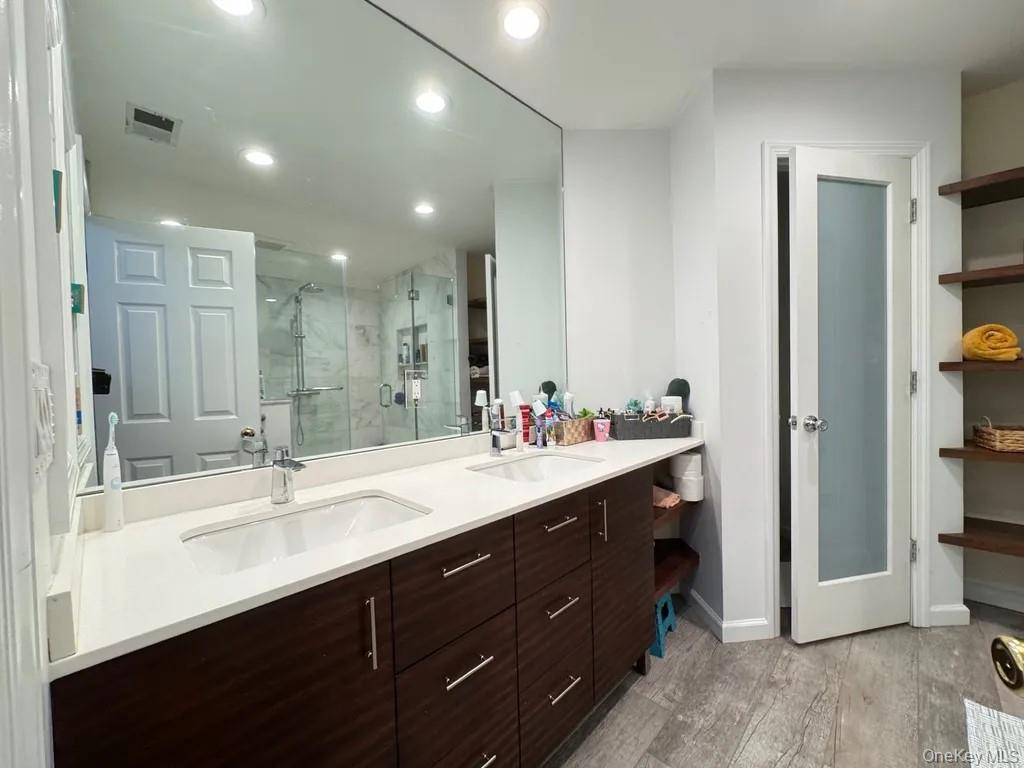 103 Sunflower Ridge Road Centereach, NY 11720 - Photo 4 of 16 a bathroom with a sink double vanity and a mirror