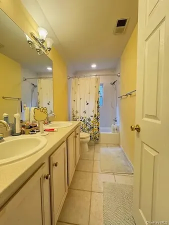 a bathroom with a sink mirror and a shower
