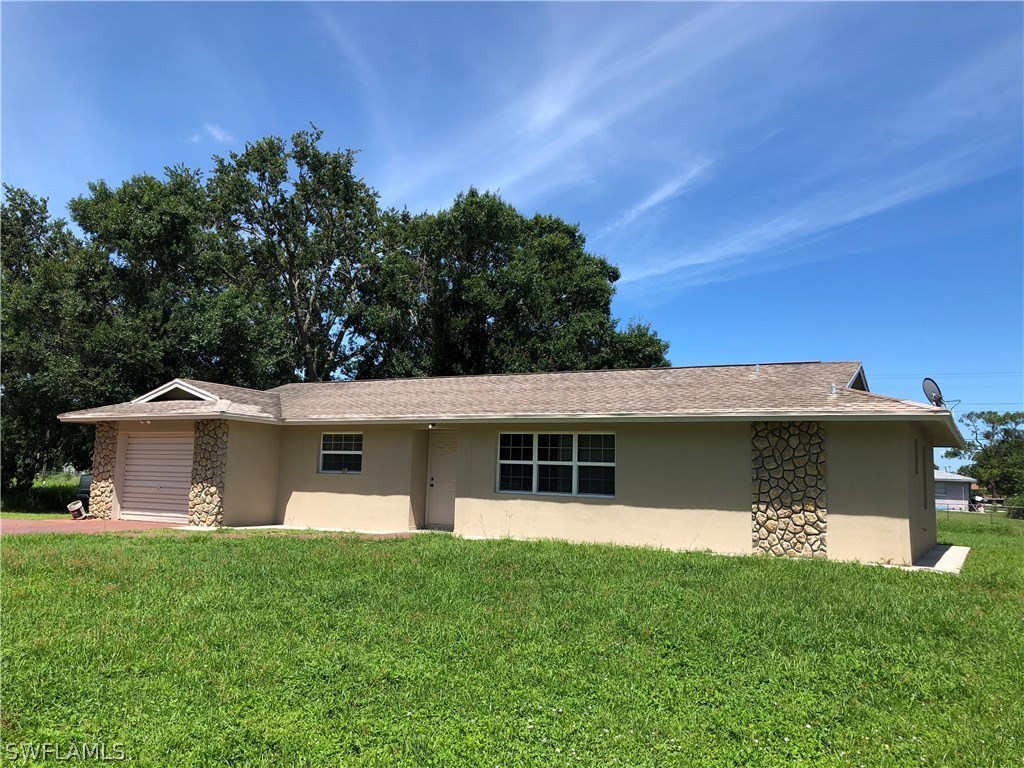 19 Connecticut Road Lehigh Acres, FL 33936 - Photo 1 of 26 a view of a house with a backyard