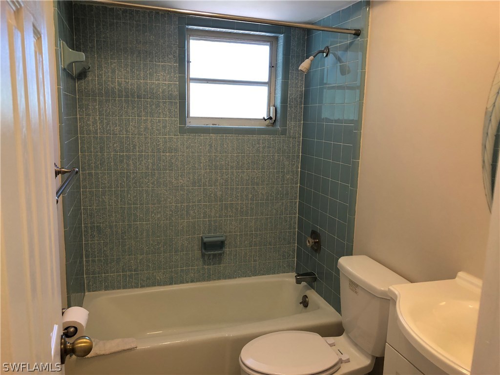 19 Connecticut Road Lehigh Acres, FL 33936 - Photo 13 of 26 a bathroom with a toilet and a bathtub