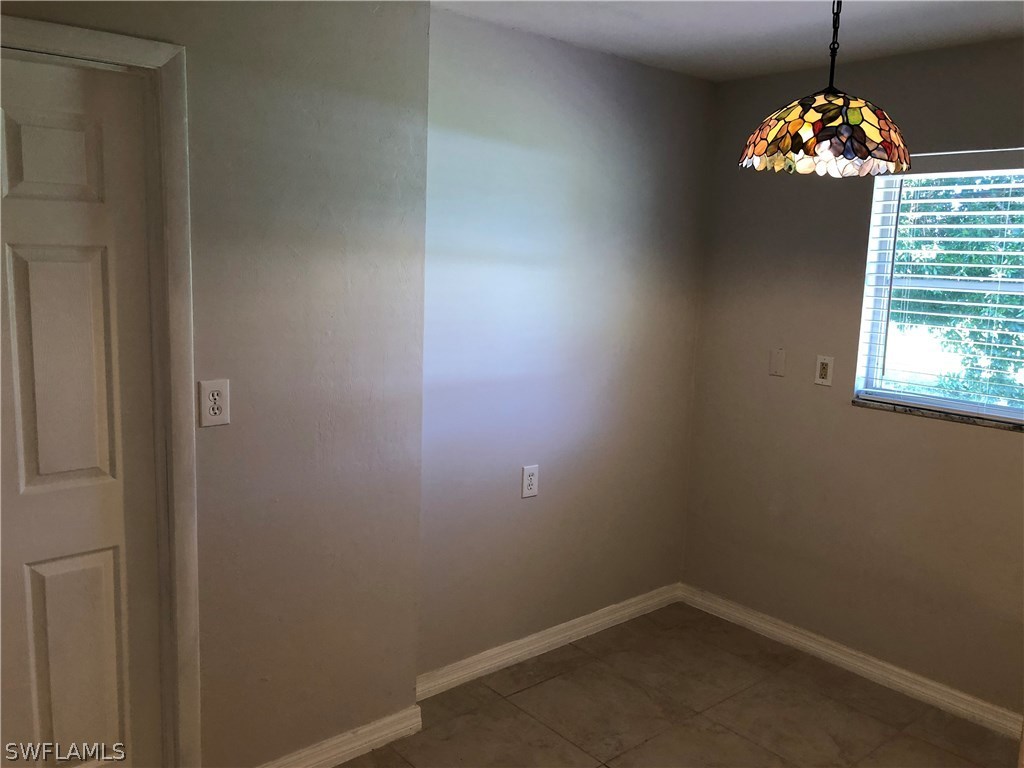 19 Connecticut Road Lehigh Acres, FL 33936 - Photo 18 of 26 a view of a chandelier in a room
