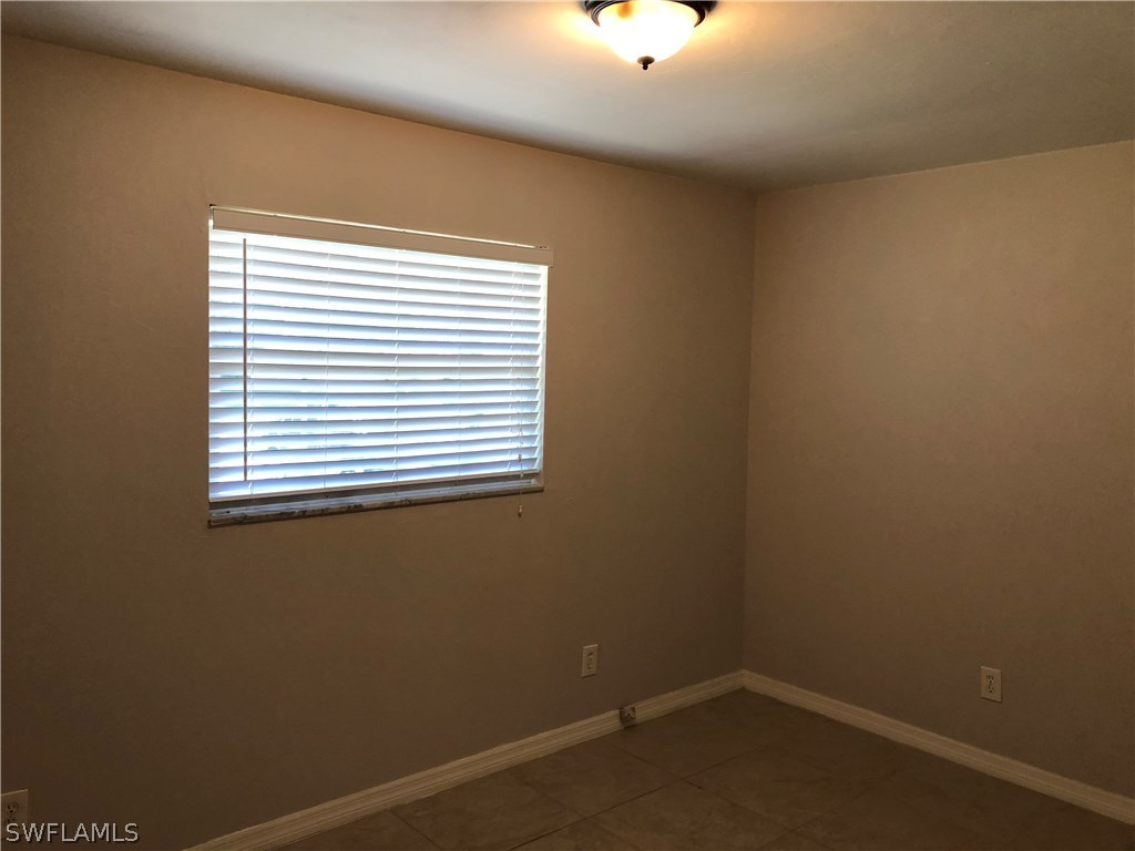 19 Connecticut Road Lehigh Acres, FL 33936 - Photo 21 of 26 an empty room with a window