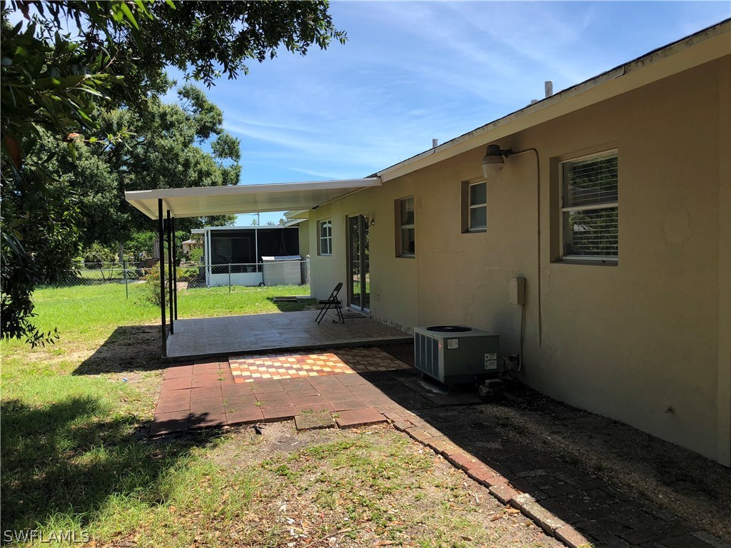 19 Connecticut Road Lehigh Acres, FL 33936 - Photo 24 of 26 a view of a house with backyard and sitting area