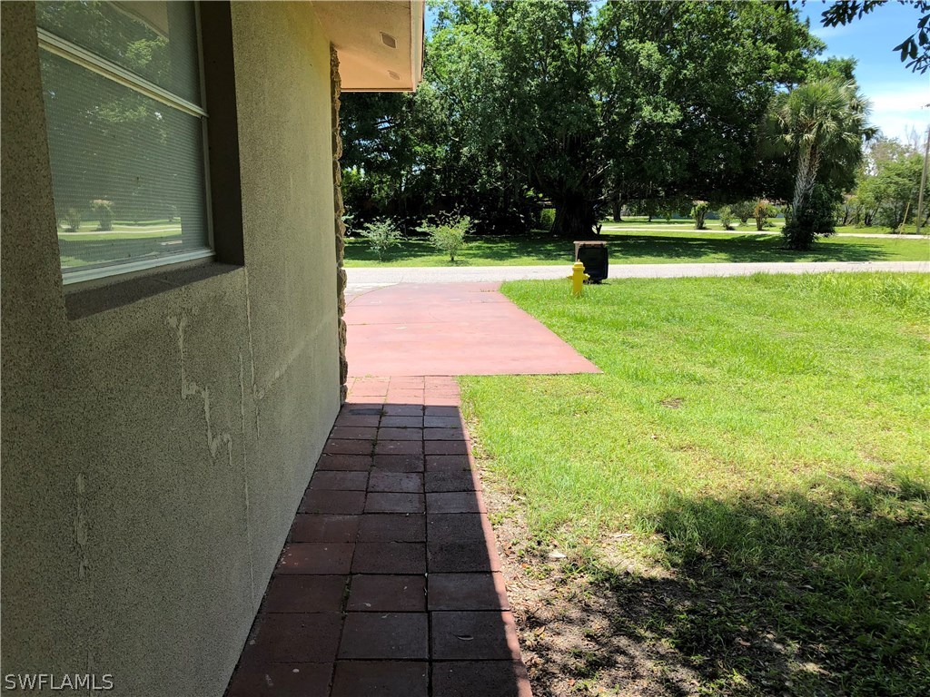 19 Connecticut Road Lehigh Acres, FL 33936 - Photo 25 of 26 a view of a backyard with large trees