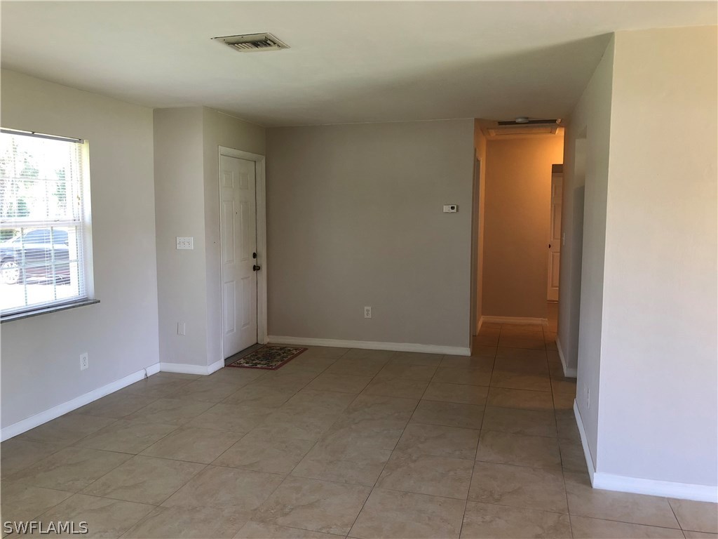 19 Connecticut Road Lehigh Acres, FL 33936 - Photo 9 of 26 an empty room with windows and closet