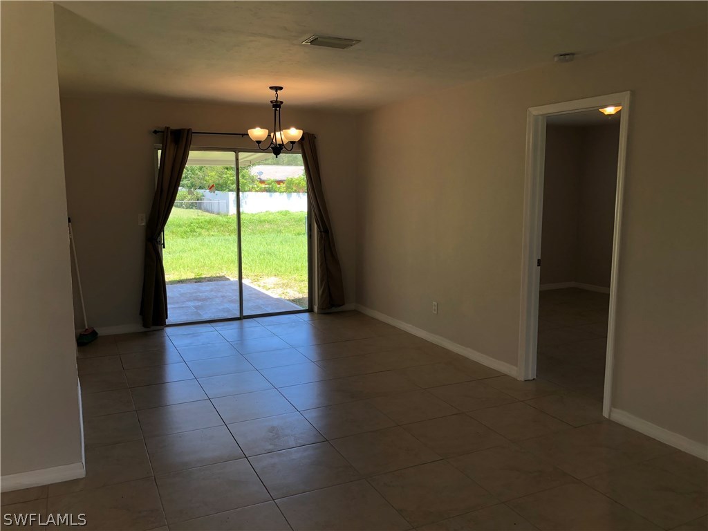 19 Connecticut Road Lehigh Acres, FL 33936 - Photo 10 of 26 an empty room with windows and yard