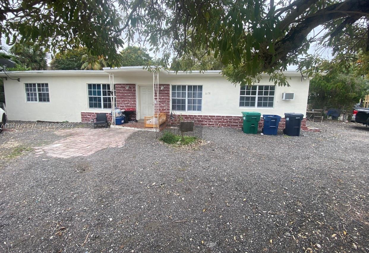3170 Northwest 100th Street Miami, FL 33147 - Photo 1 of 7 front view of a house with a patio