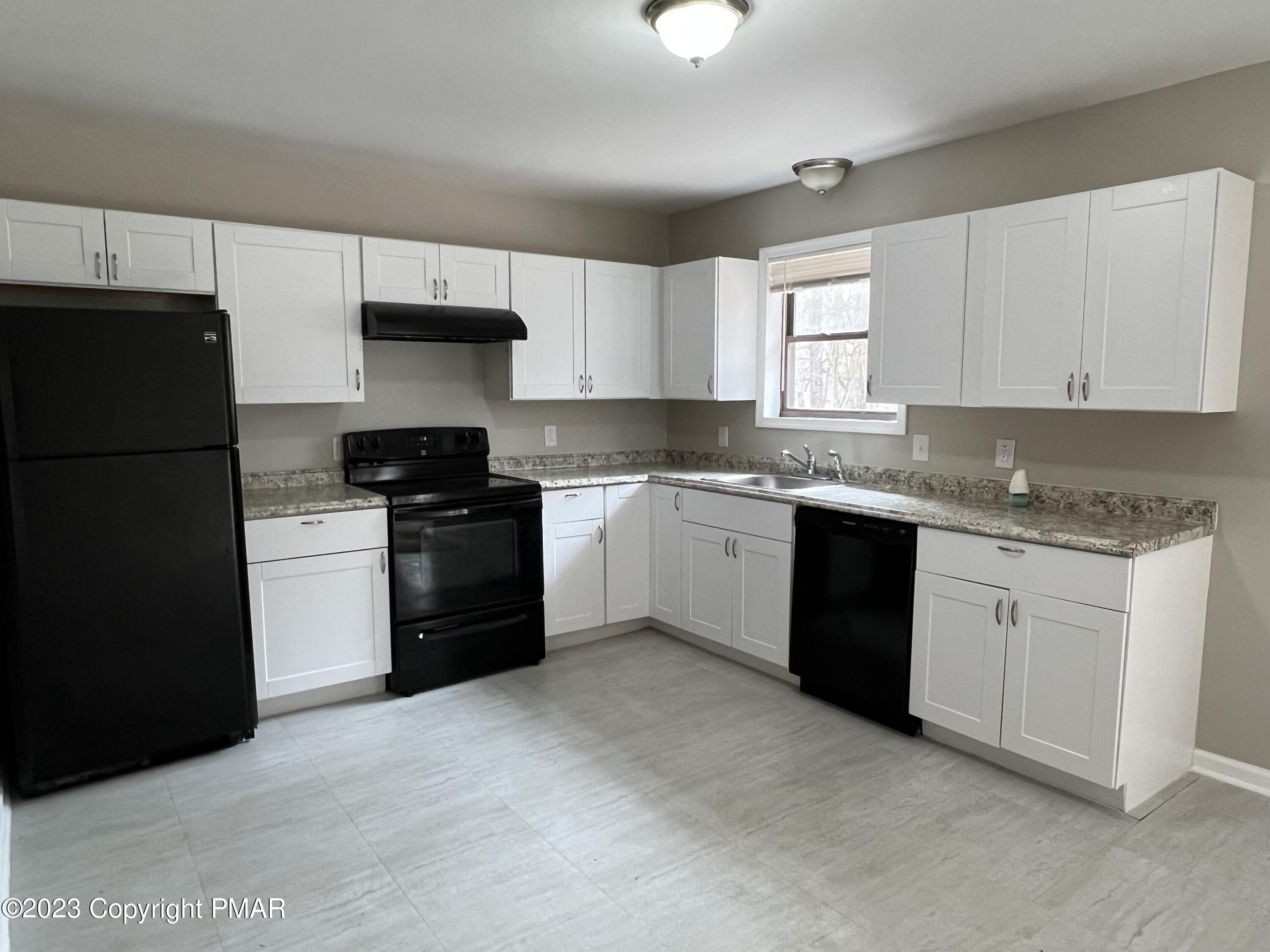143 Granite Road Long Pond, PA 18334 - Photo 2 of 23 a kitchen with granite countertop a cabinets and white stainless steel appliances