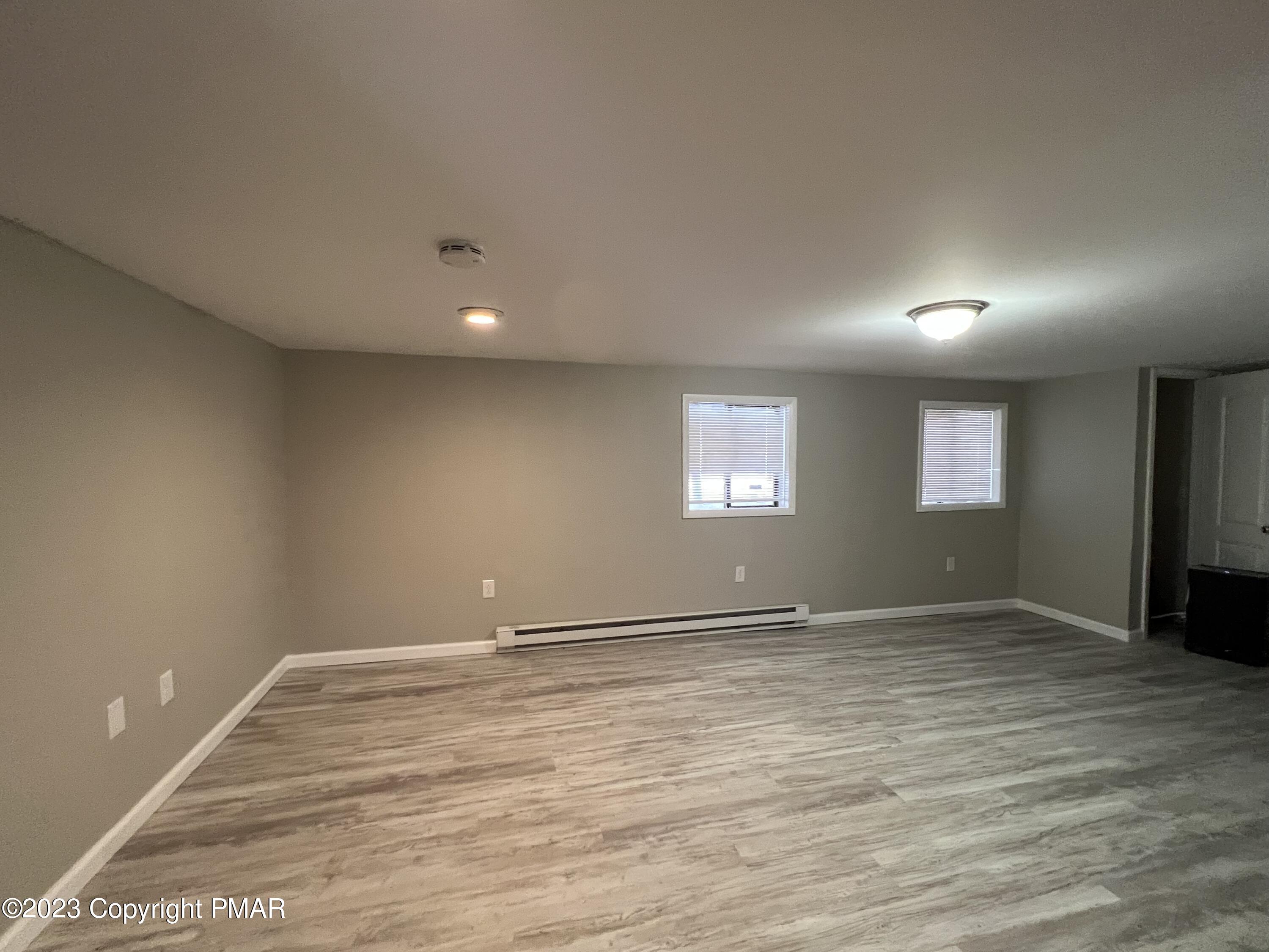 143 Granite Road Long Pond, PA 18334 - Photo 3 of 23 a view of an empty room with wooden floor and a window