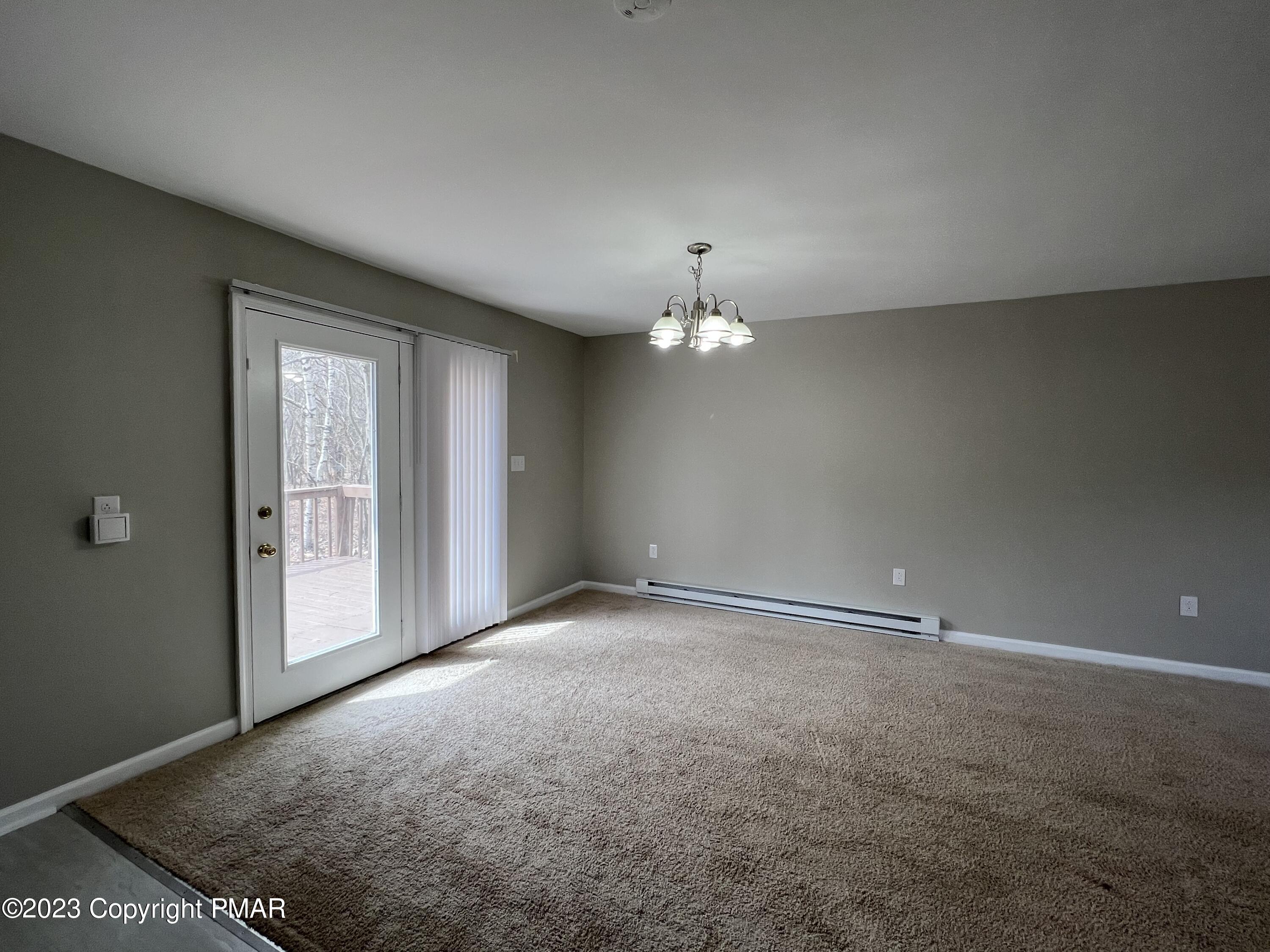 143 Granite Road Long Pond, PA 18334 - Photo 4 of 23 an empty room with chandelier fan and windows
