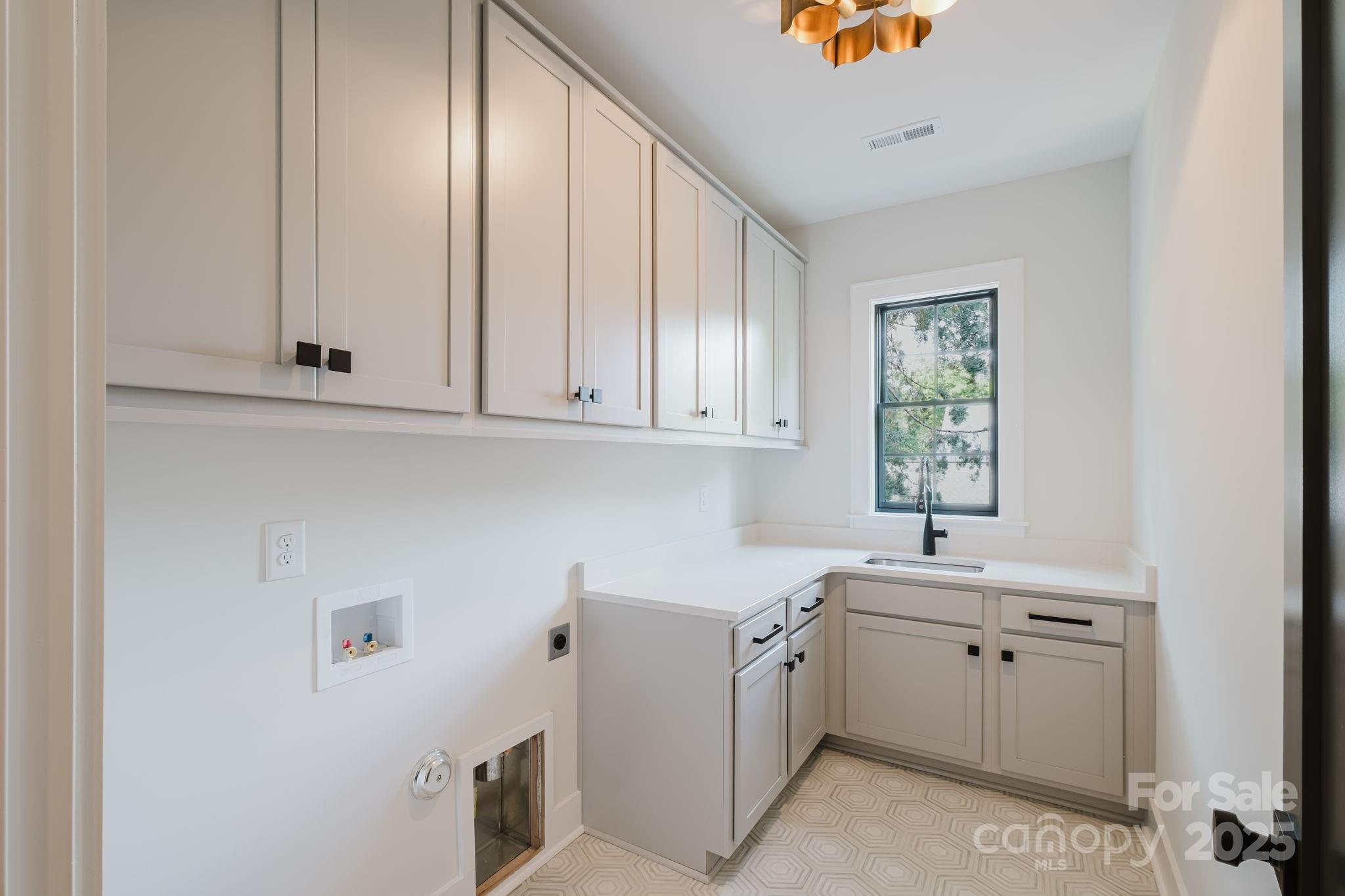 1625 Club Road Charlotte, NC 28205 - Photo 19 of 31 a utility room with cabinets washer and dryer