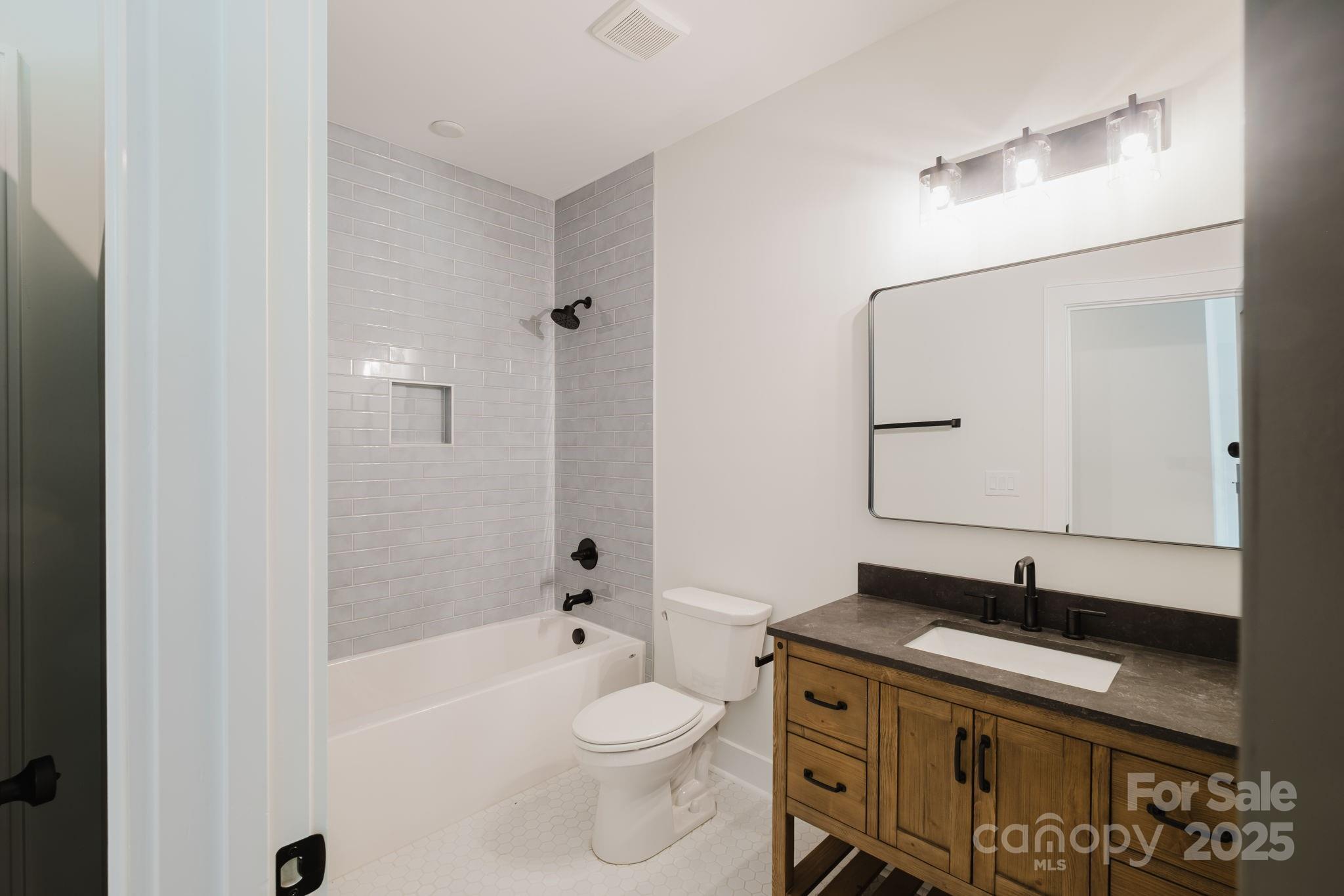 1625 Club Road Charlotte, NC 28205 - Photo 20 of 31 a bathroom with a sink a toilet and shower
