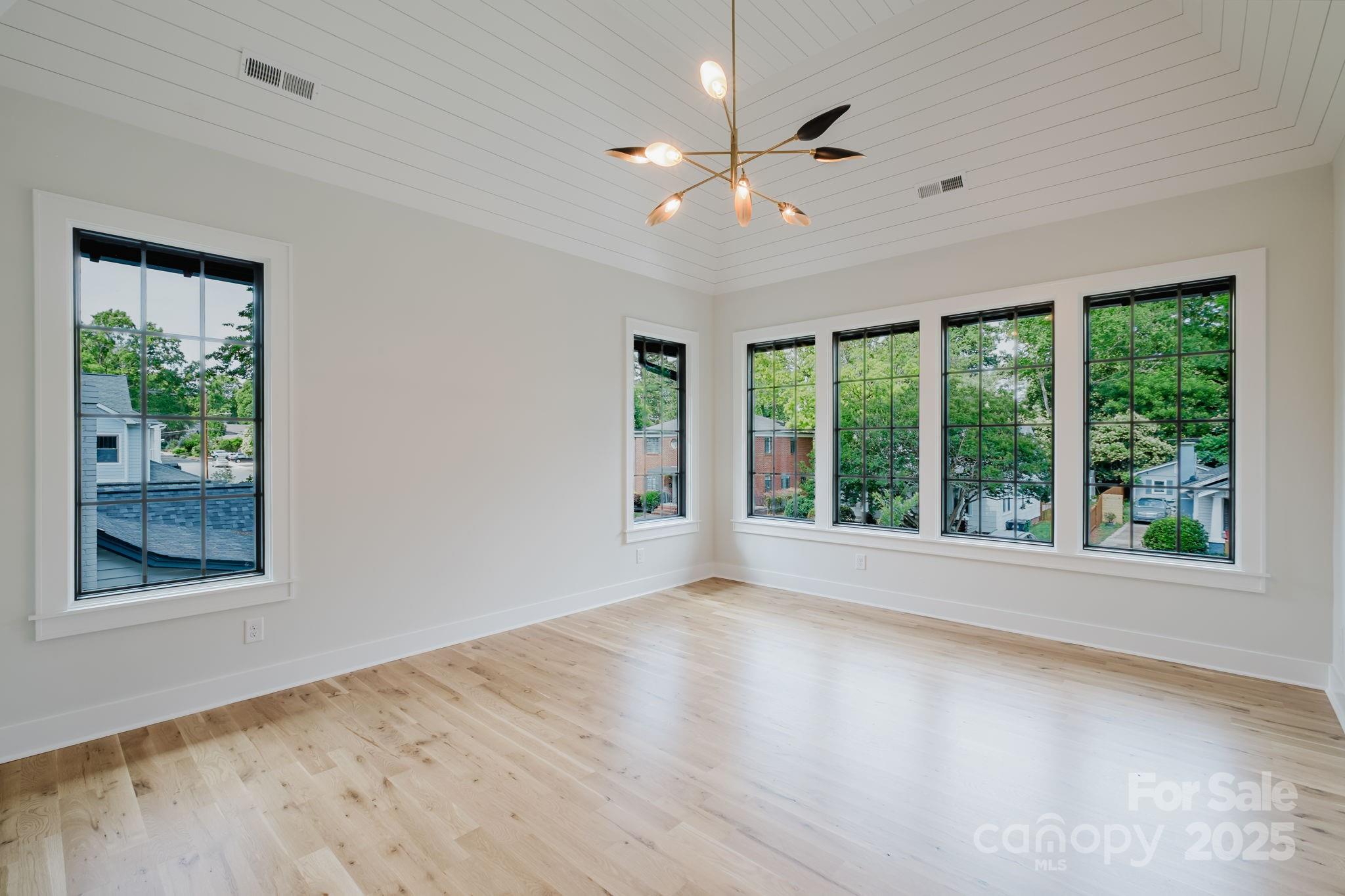 1625 Club Road Charlotte, NC 28205 - Photo 21 of 31 a view of an empty room with wooden floor and a window