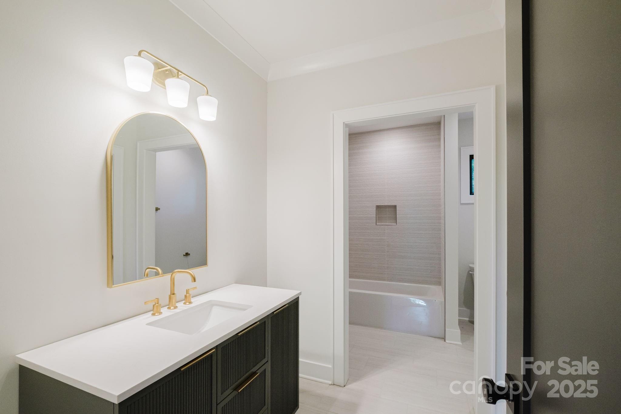 1625 Club Road Charlotte, NC 28205 - Photo 22 of 31 a bathroom with a sink a toilet and shower