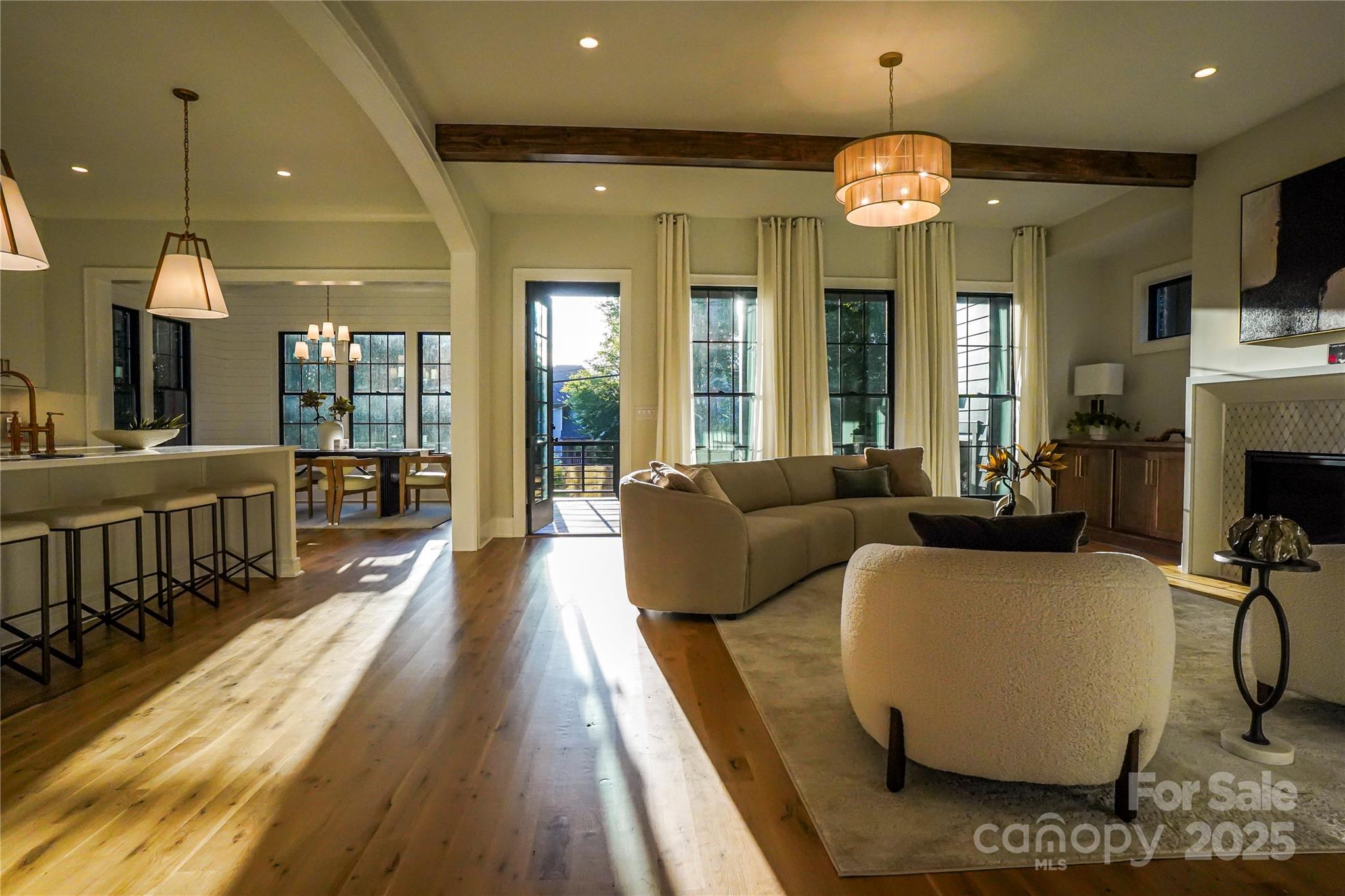 1625 Club Road Charlotte, NC 28205 - Photo 6 of 31 a living room with furniture a large dining table and a chandelier