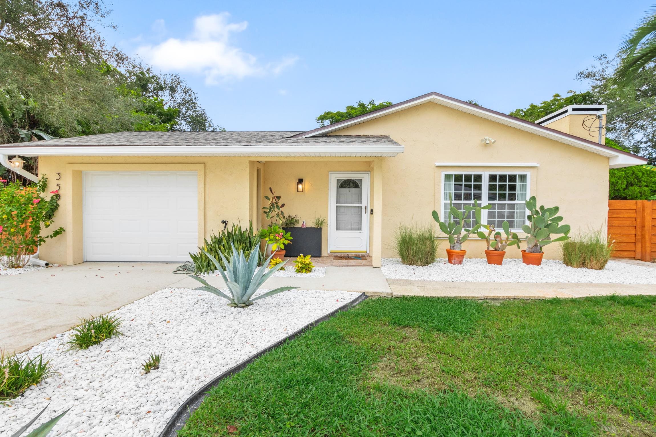359 Shamrock Road St. Augustine, FL 32086 - Photo 1 of 39 a view of a backyard with plants and a patio
