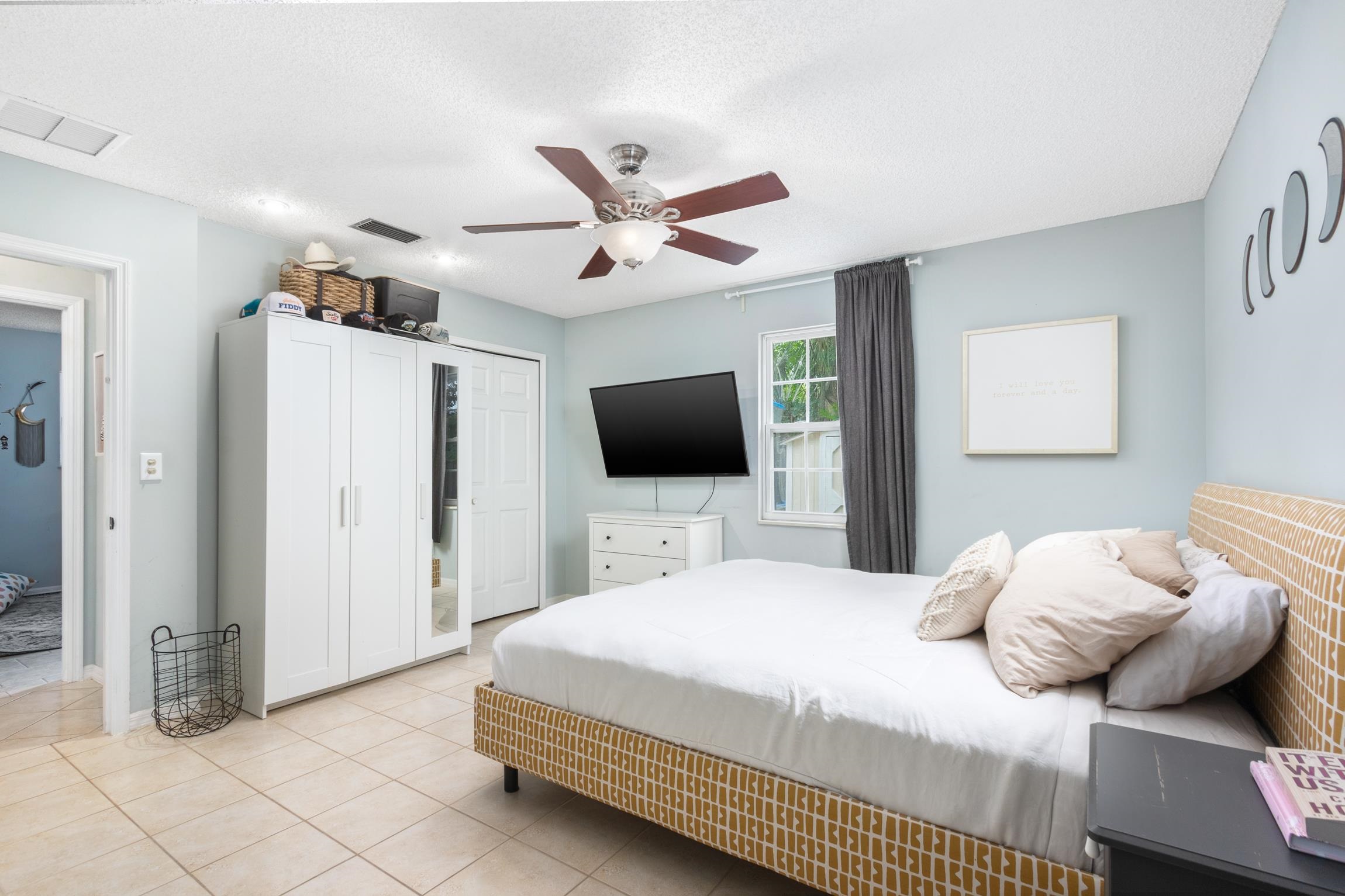 359 Shamrock Road St. Augustine, FL 32086 - Photo 17 of 39 a bedroom with a bed and a flat screen tv